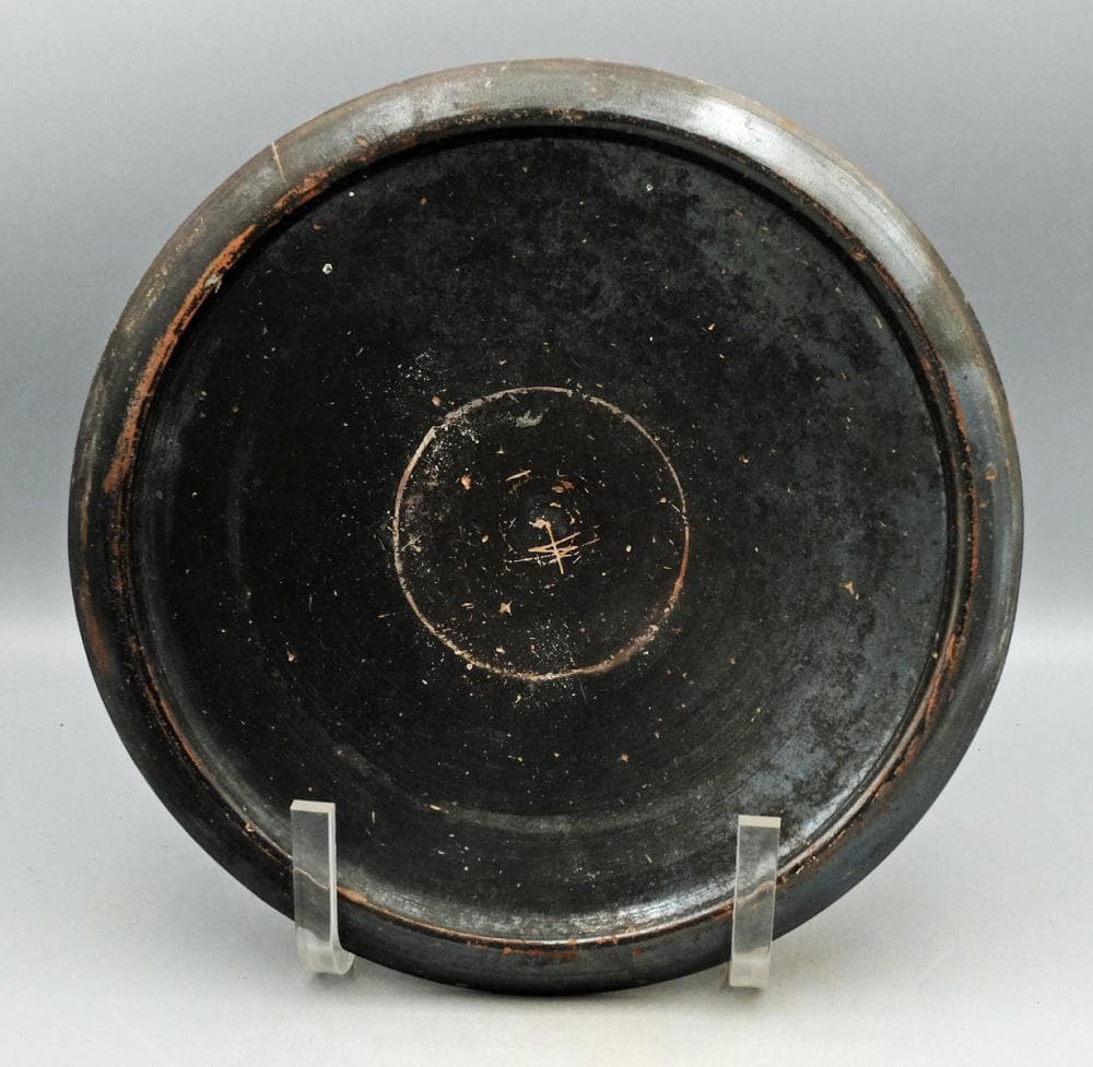 An attractive Greek black glazed plate