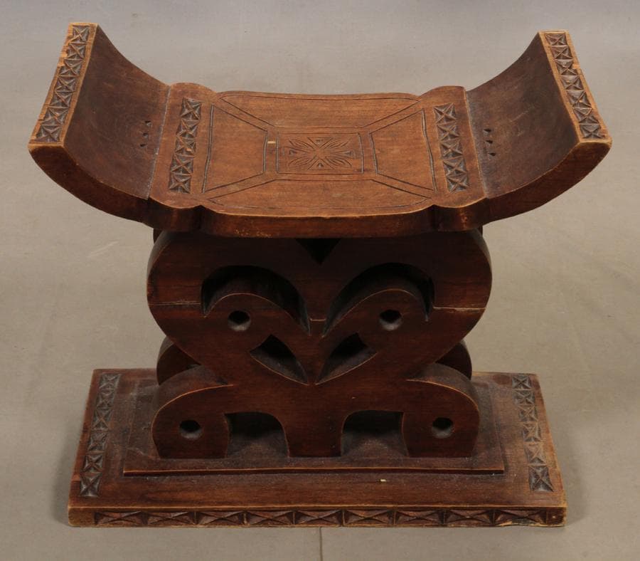 Tribal carved wood chair, h 18", l 22"