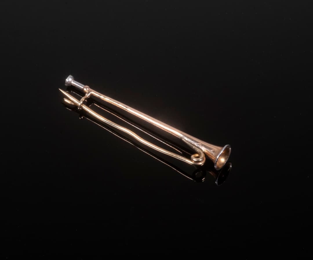 GOLD TRUMPET BROOCH