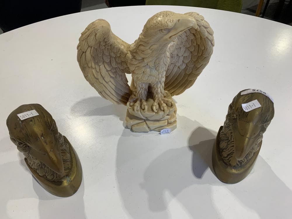Pair of brass eagle head book ends and eagle figurine in resin