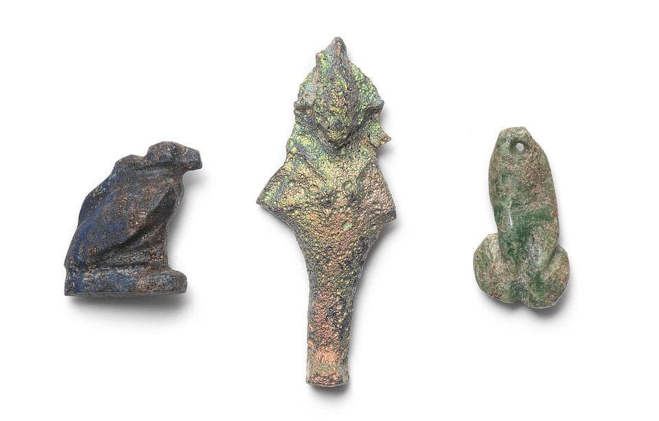 An Egyptian lapis lazuli vulture amulet and an Egyptian...