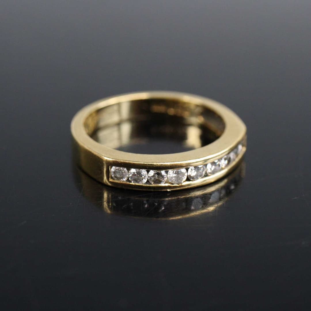 Lot 2008 - An 18ct yellow gold diamond half eternity