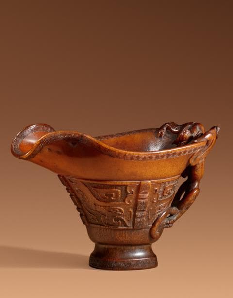 A fine archaistic rhinoceros libation cup. Ming dynasty (1368-1644)