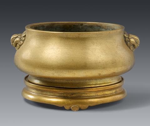 A brass incense burner with stand