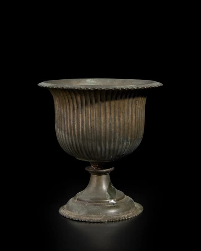 A gadrooned flaring bronze cup