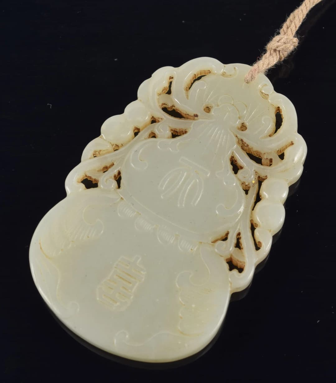 Jade pendant. China. 19th century. Double gourd form. 2.25in.