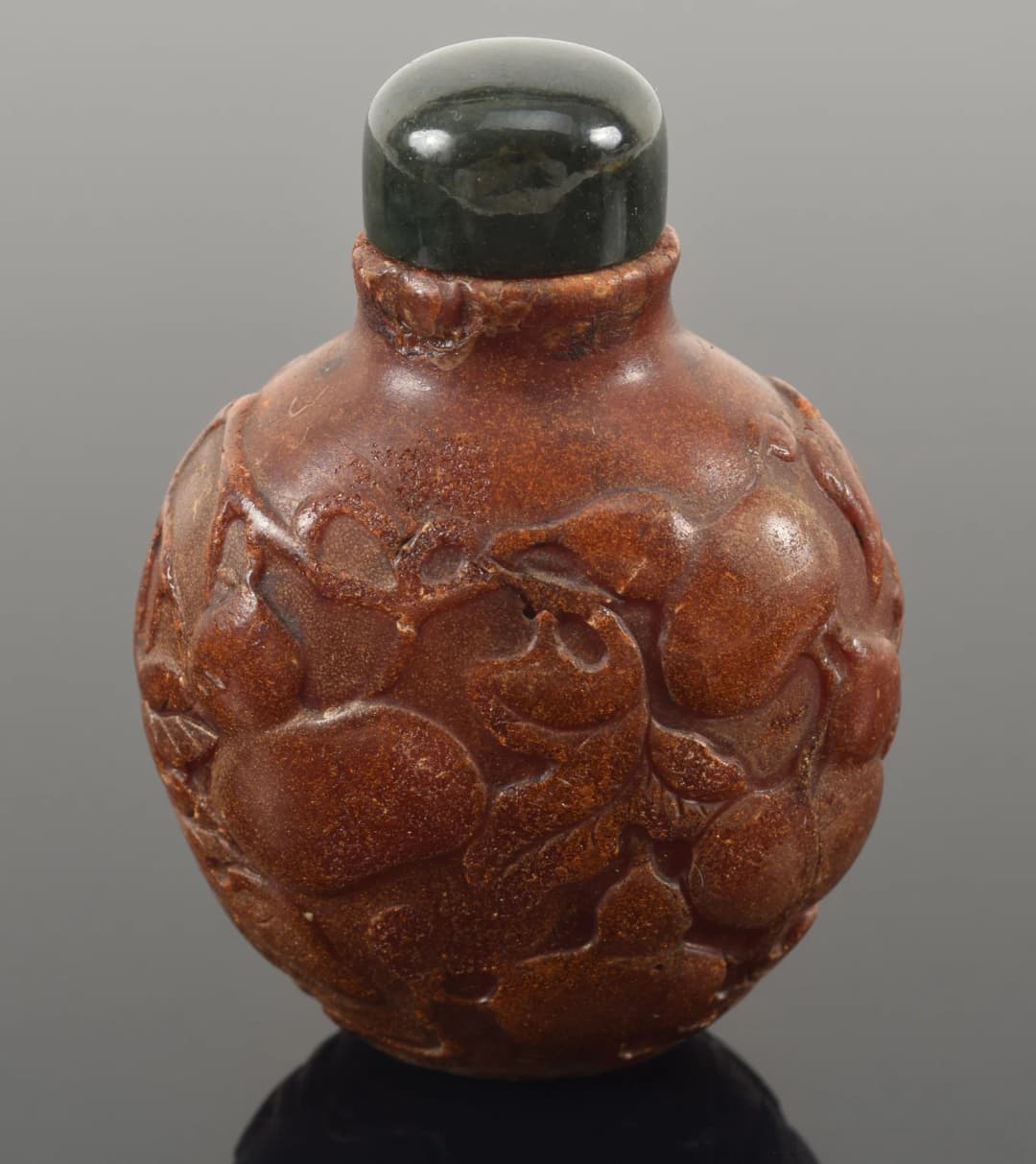 19th century Chinese carved amber snuff bottle. Allover fruit decoration.