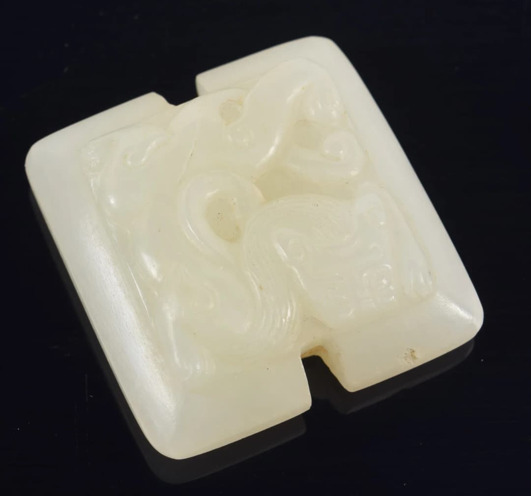 Jade pendant. China. 18th century. Surface carved with chih lung. 1.5in.