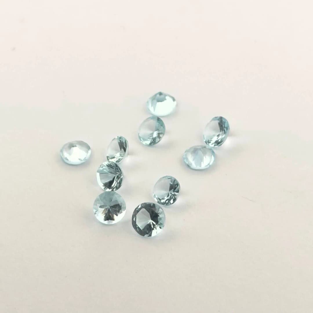 Lot of ten round aquamarines on paper. - Lot 91