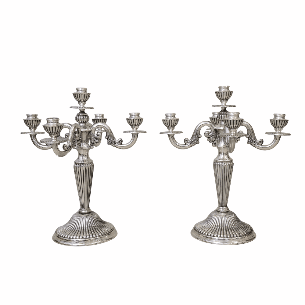 Dos candelabros de cinco luces en plata punzonada española.