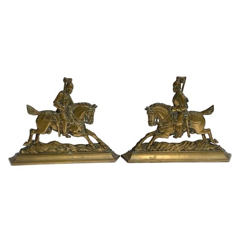 A pair of cast fireside horse brasses modelled as cavalry me...