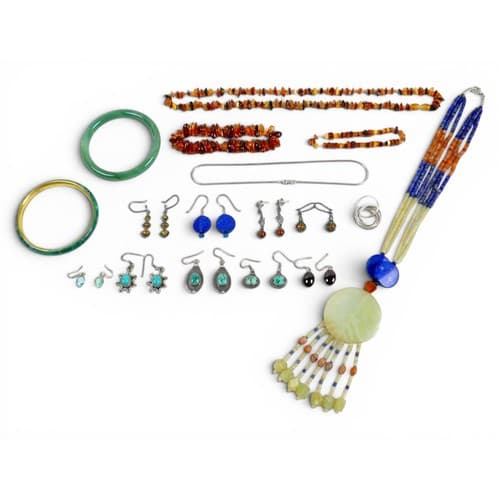 A small group of jewellery, including a jade, lapis and pink...