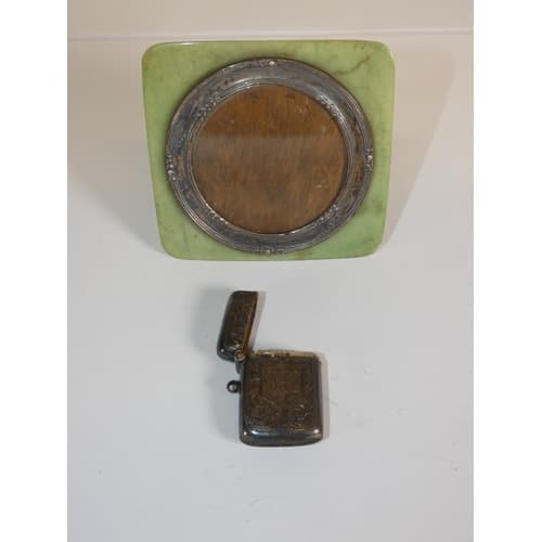Silver vesta case and a silver mounted photo frame on a jade...