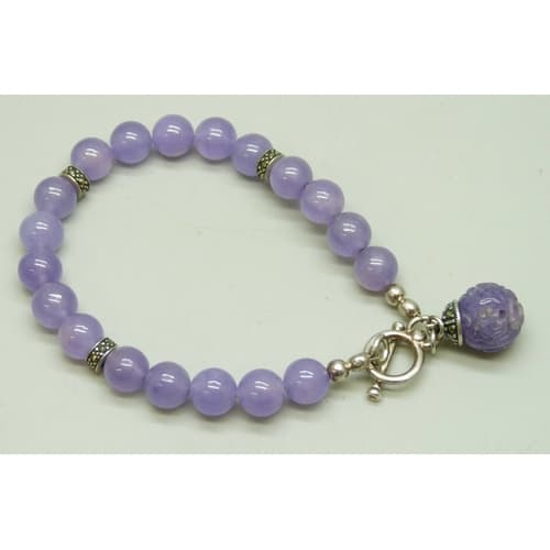 A silver, lavender jade and marcasite bracelet with a carved...
