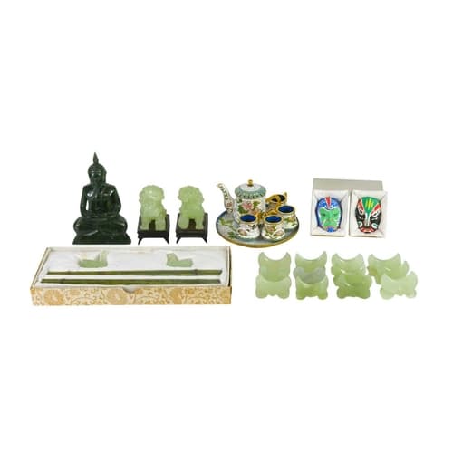 A pair of Chinese green hardstone fo dog figures. 20th centu...