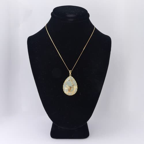 A 14ct gold mounted Jade Pendant, the pear shaped pale greed...