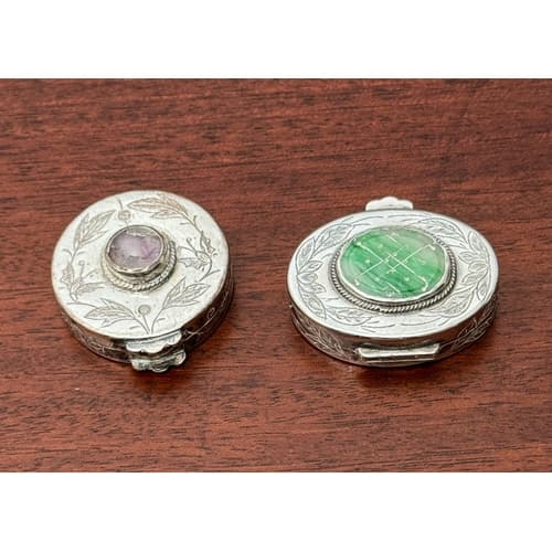 A Chinese silver and jade pill box - oval, with chased folia...