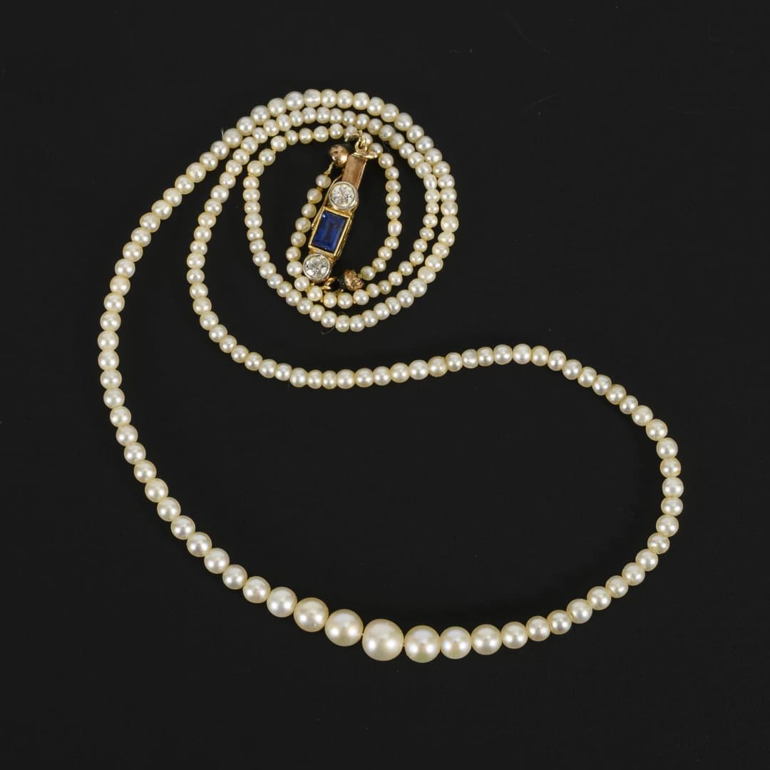Quality antique pearl necklace with decorative clasp.