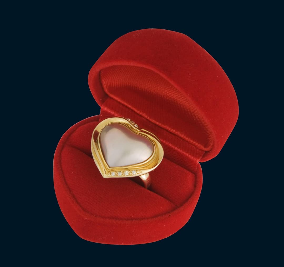 Large pearl diamond heart ring in a heart case.