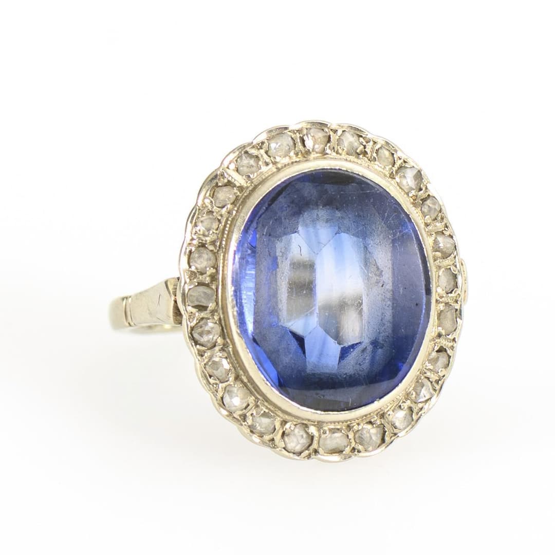 Entourage ring with blue colored stone, probably sapphire.