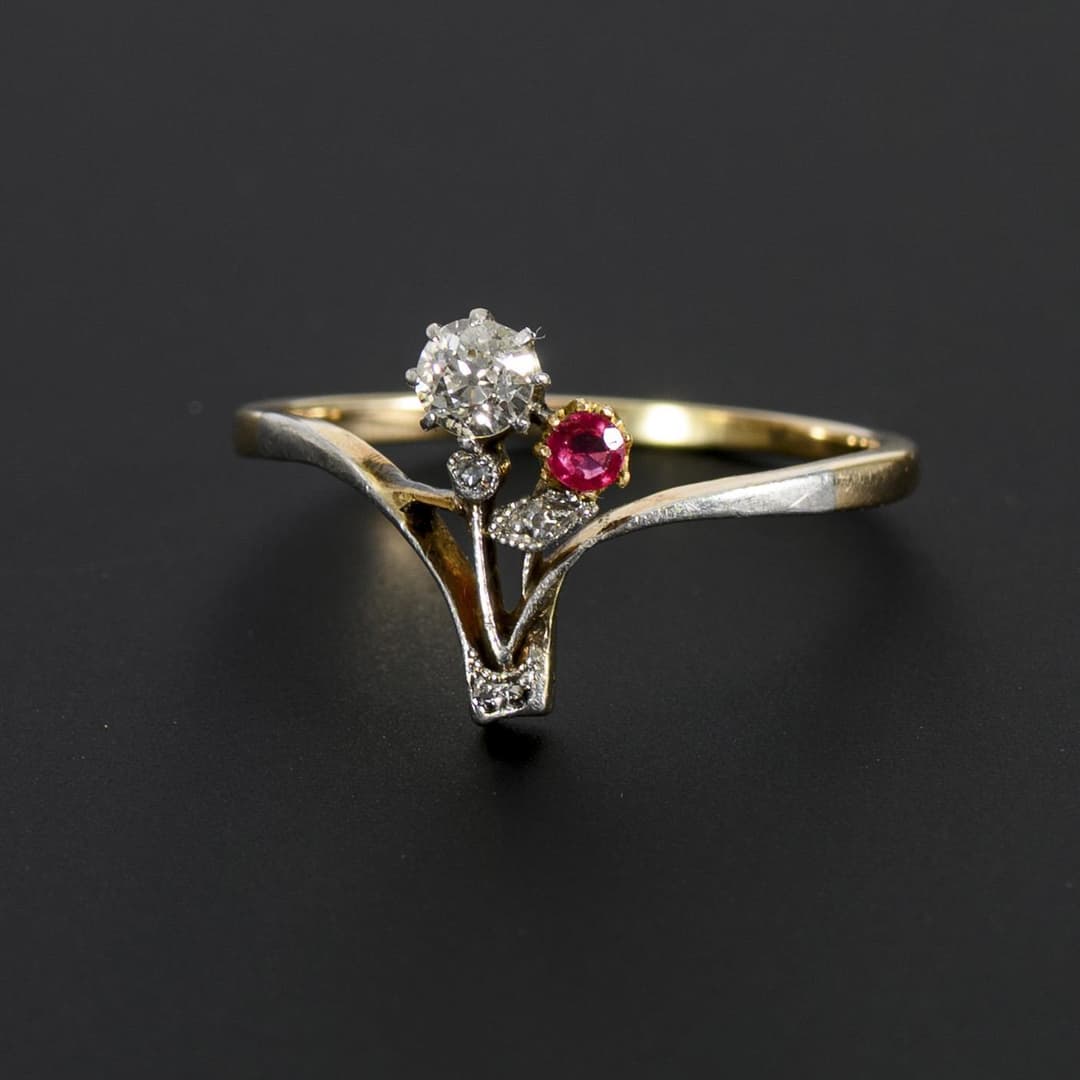 Art Nouveau ring with old-cut diamond and red gemstone.