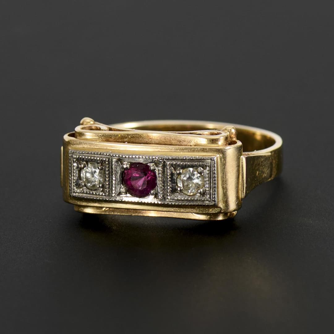Art deco ring with red colored stone and two diamonds.