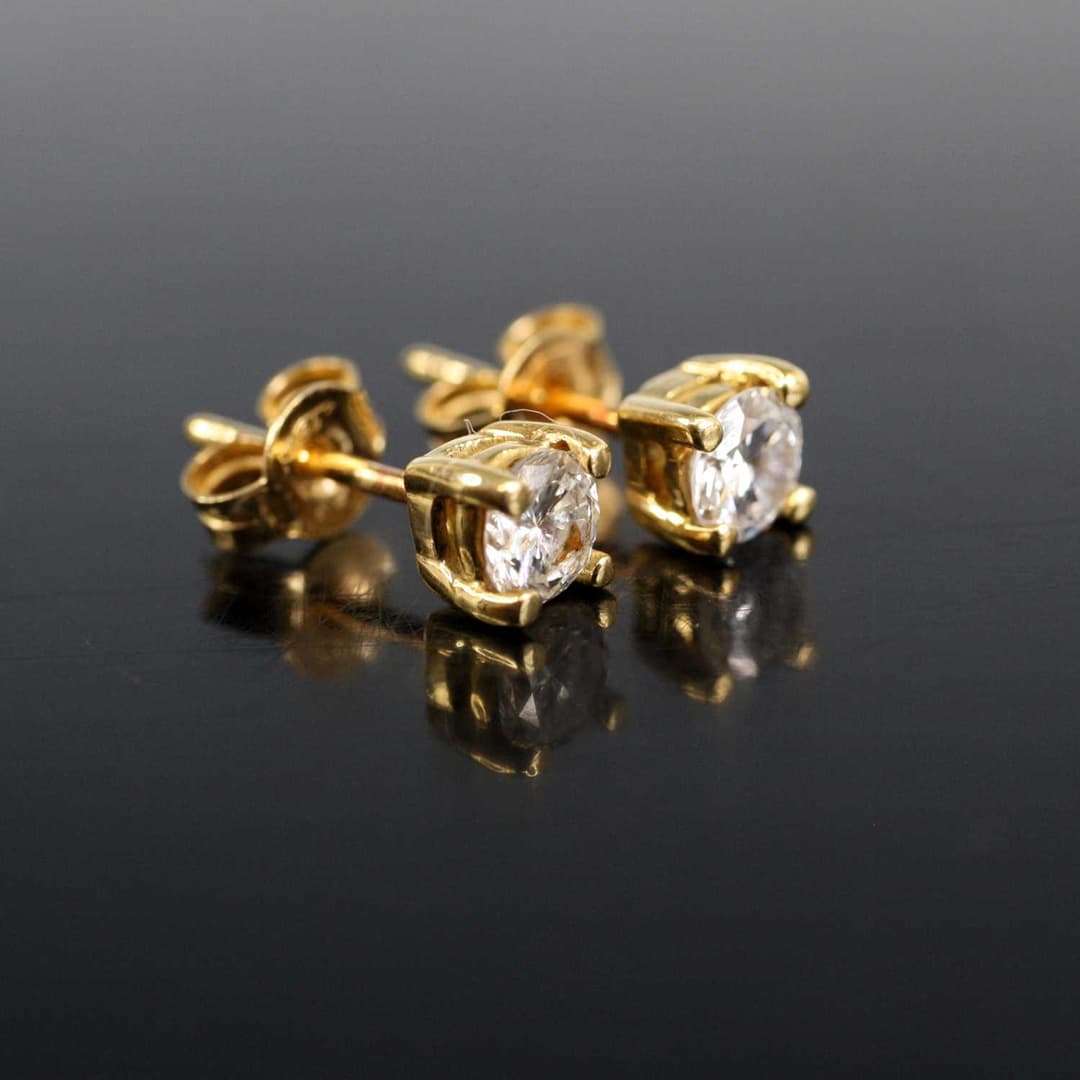 Lot 2003 - A pair of yellow metal diamond single stone