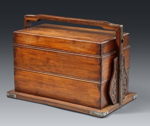 A rosewood three-tiered travelling or knick knack box. In the style
