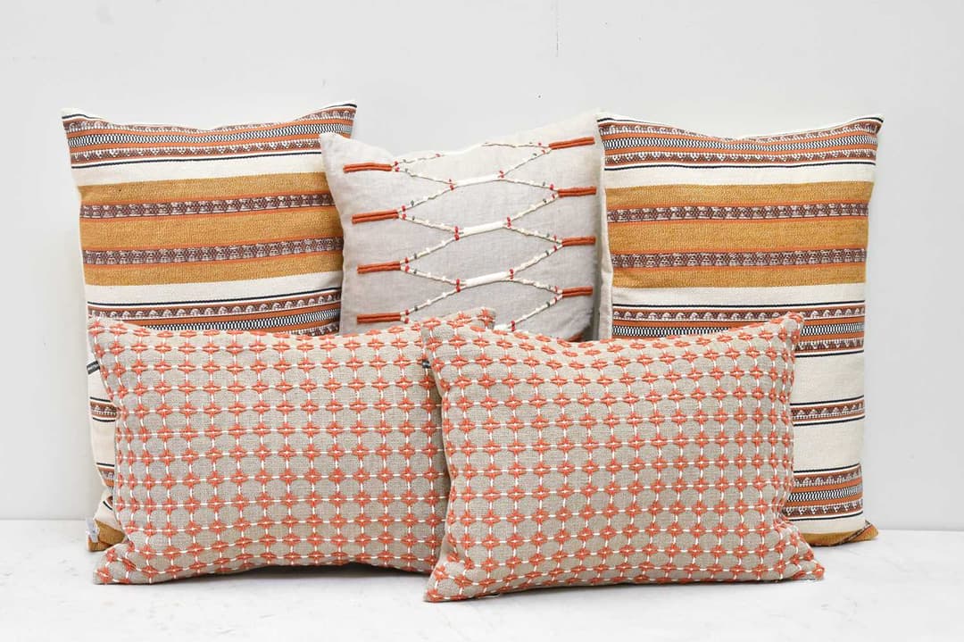 WILLIAM YEOWARD; five tan cushions (5)
