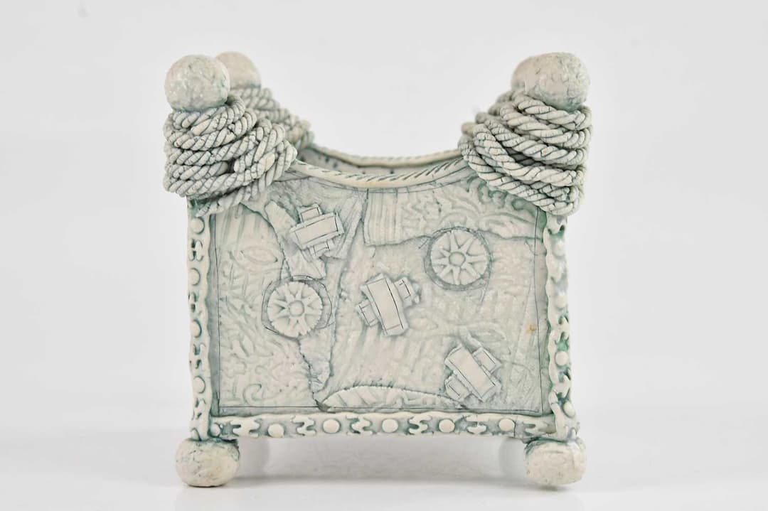 LARA SCOBIE; a small porcelain square box with applied detail