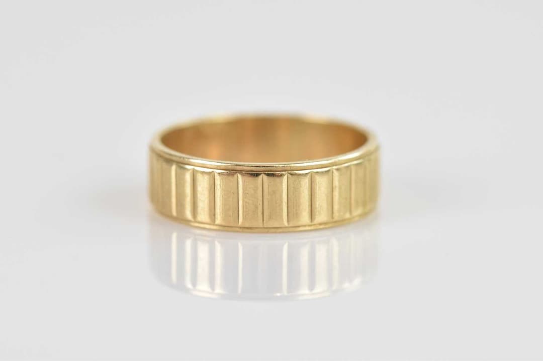 A 9ct textured yellow gold wedding band