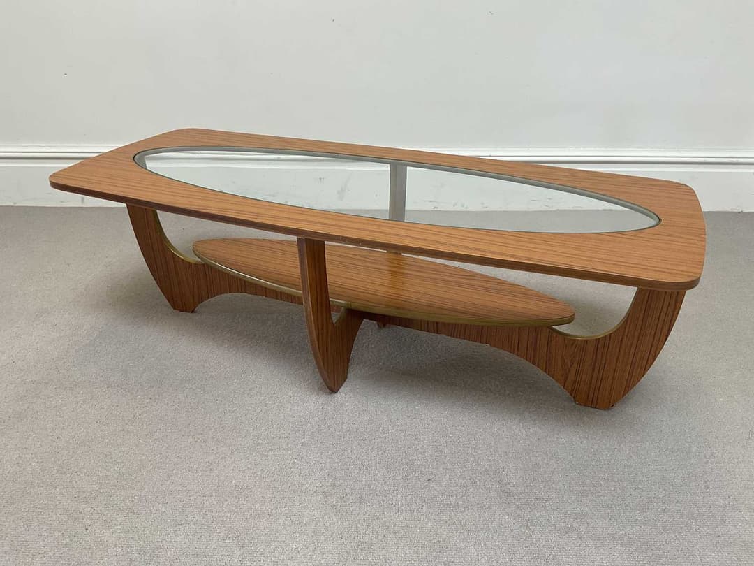 A 1970s teak effect glass top coffee table