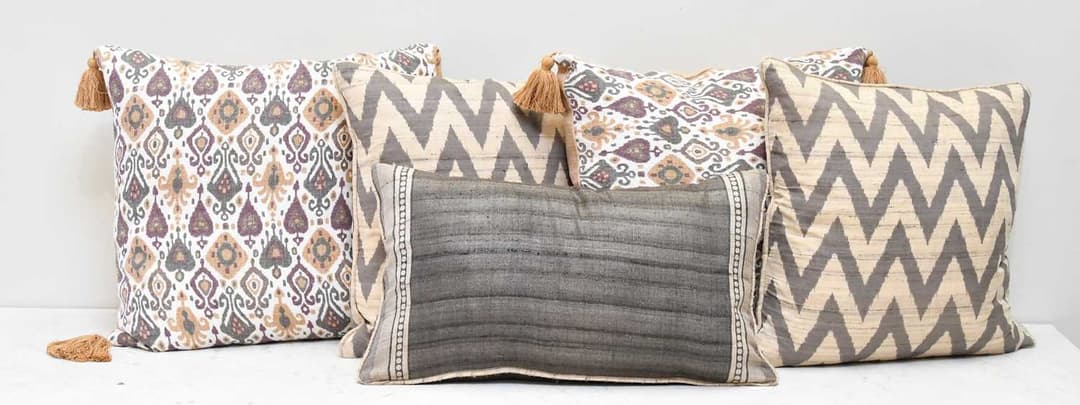 OKA; five tan and brown cushions (5)