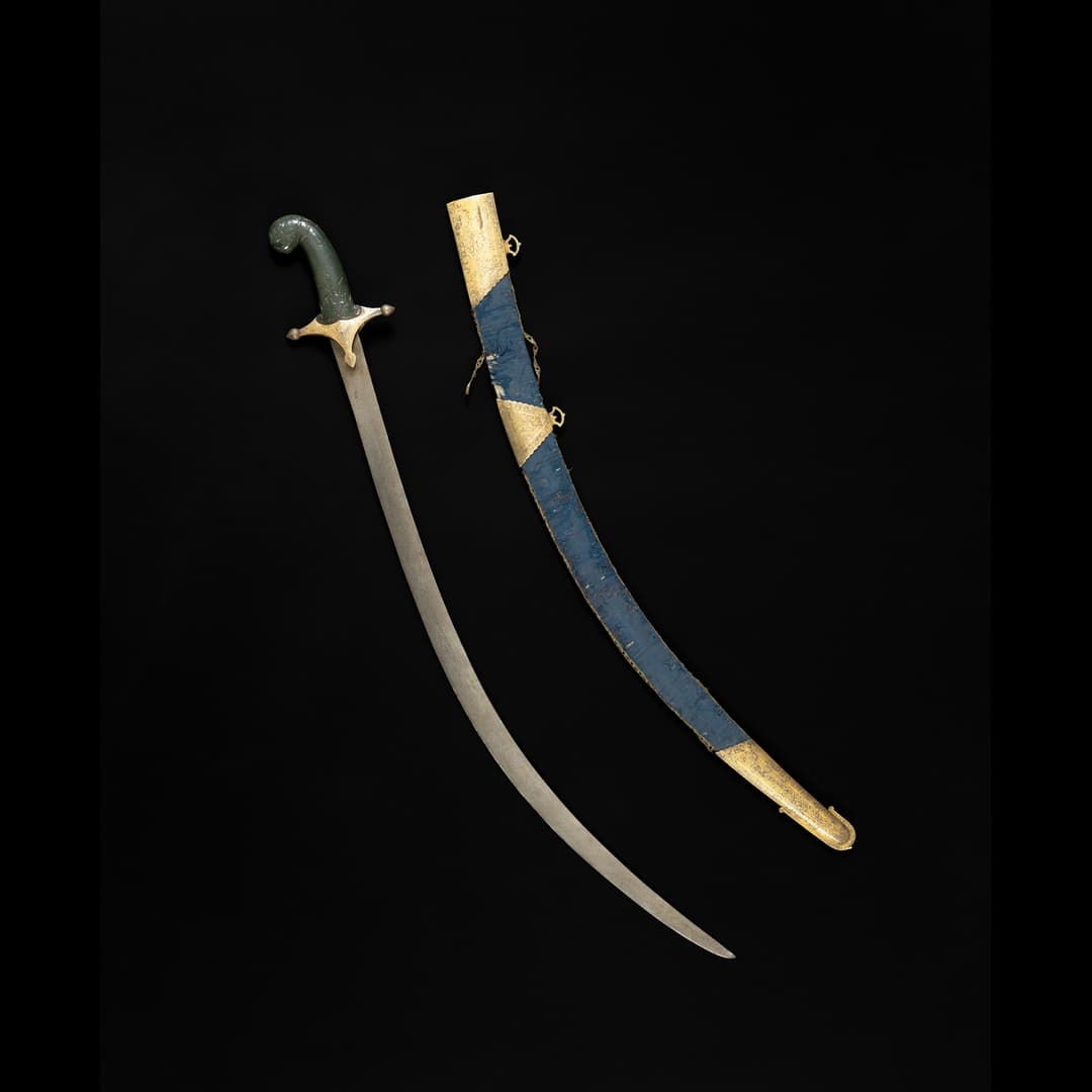 A MUGHAL JADE-HILTED STEEL SWORD (TALWAR)