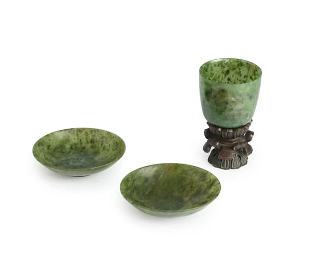 A pair of Chinese spinach green jade saucers and a cup...
