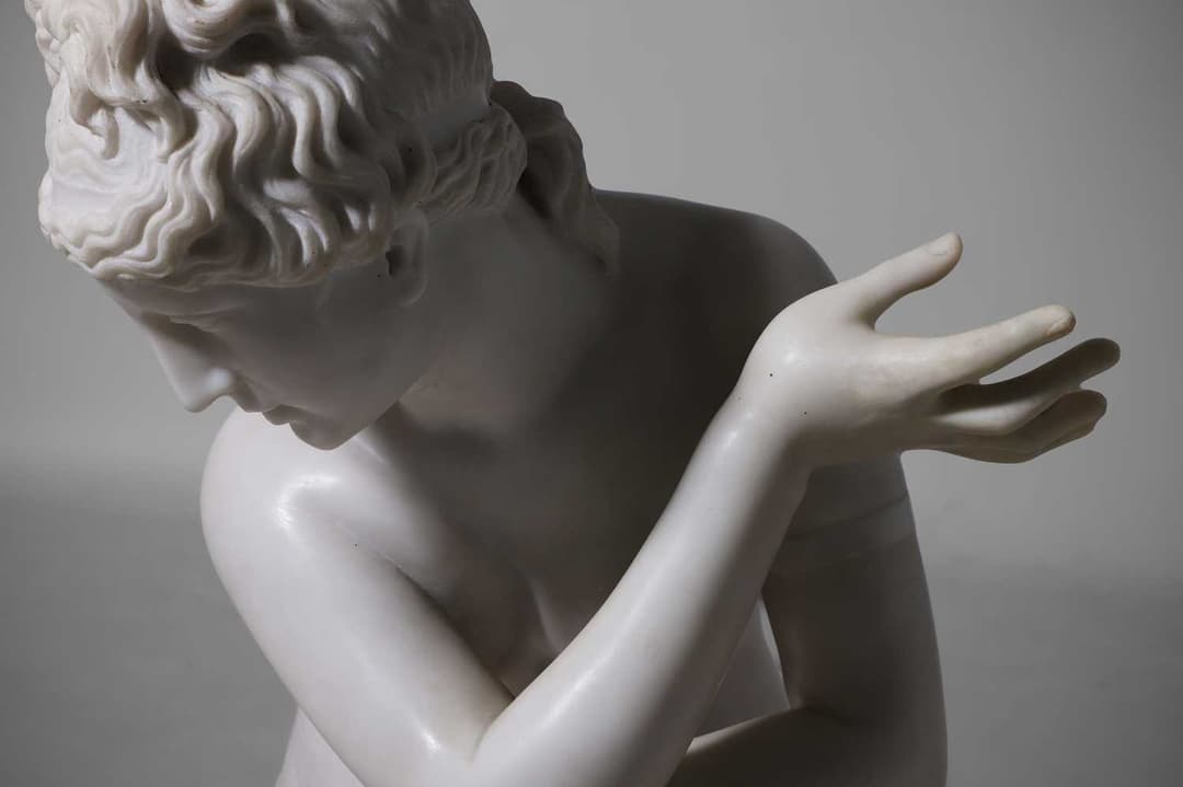 A large marble figure of 'The Crouching Venus' 20th century, Italian