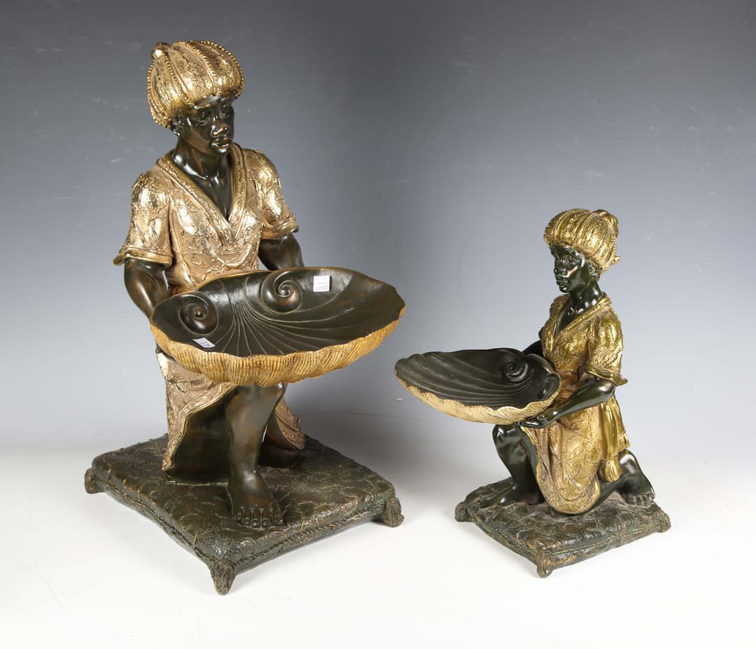 A modern cast composition model of a kneeling blackamoor figure, holding