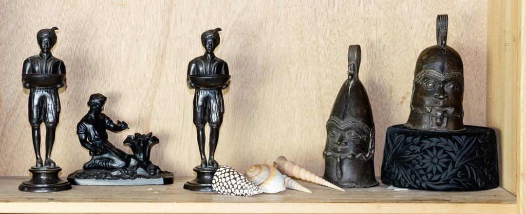 An assembled group including African style figural bells