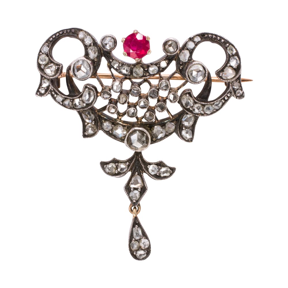A diamond, ruby, and blackened silver topped 18k gold brooch