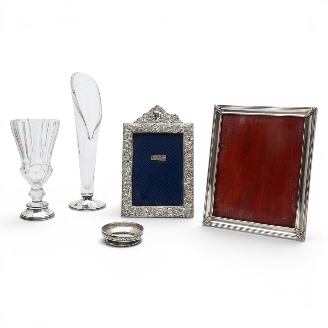 Two silver picture frames, and two crystal and silver vases.
