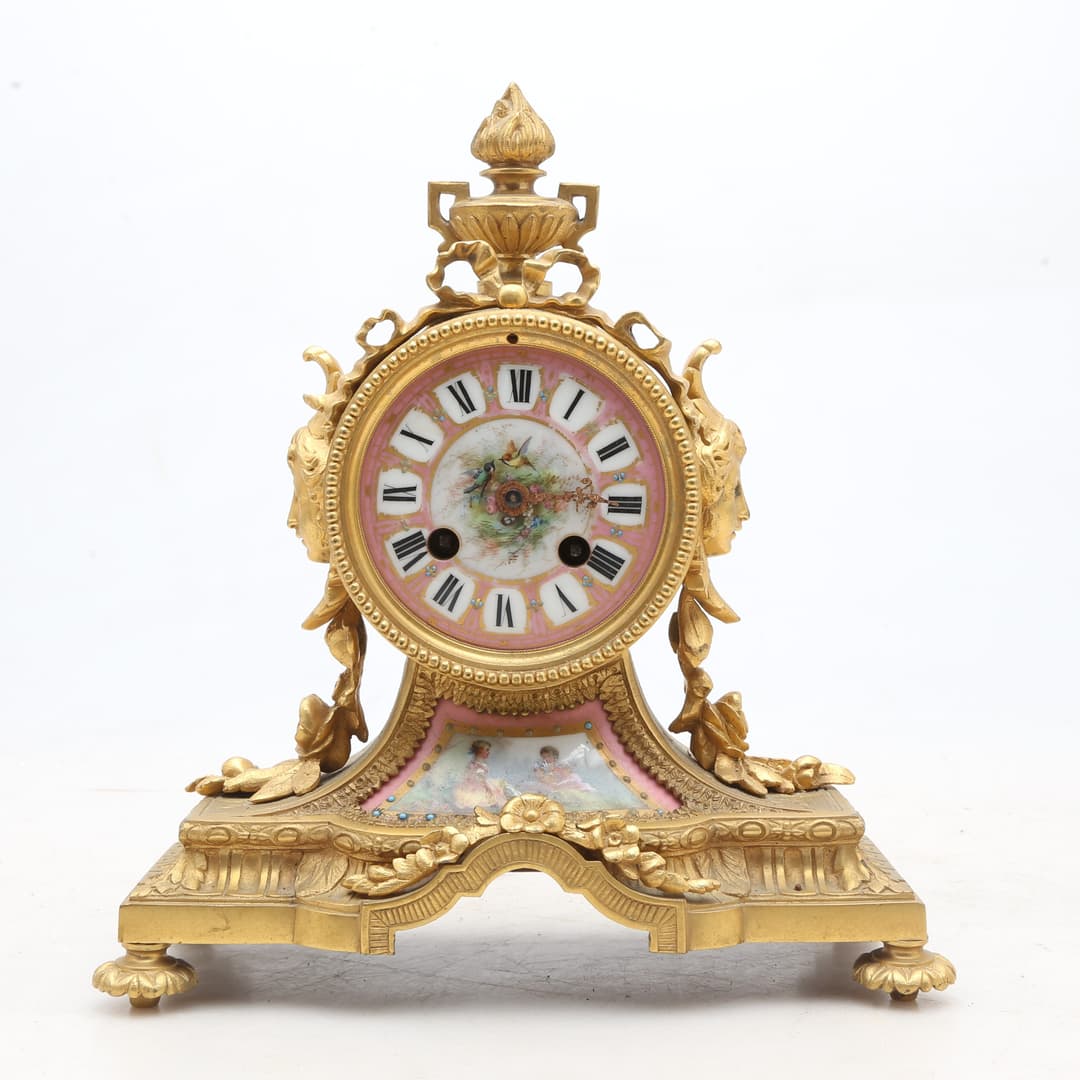 Rengency style table clock in gilt bronze and “rose Pompadour" porcelain