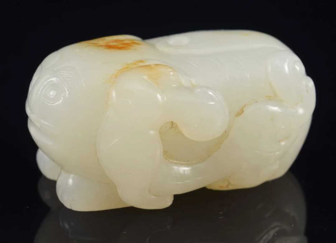 Jade pendant. China. 18th century. Pure white stone with a russet