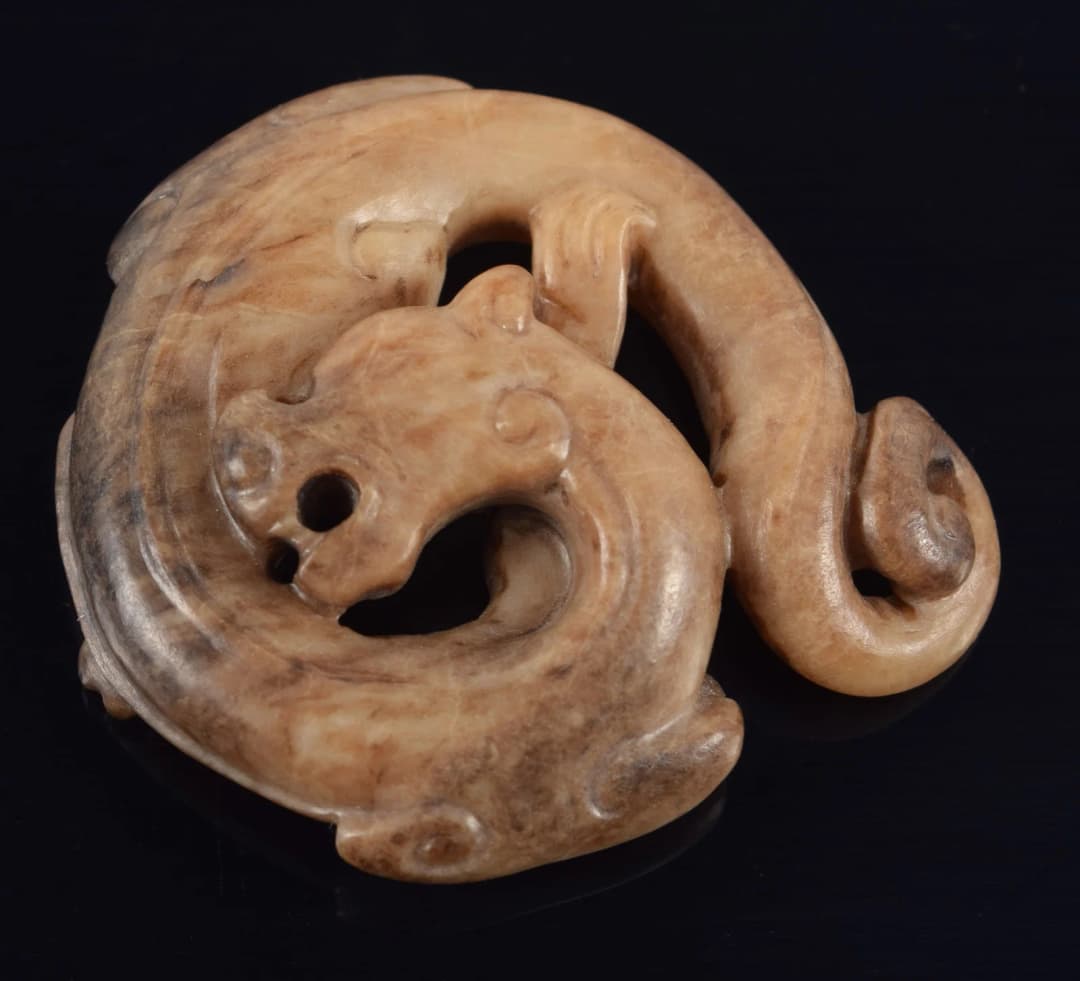 Jade pendant. China. Liao period. Brownish colored jade carved in