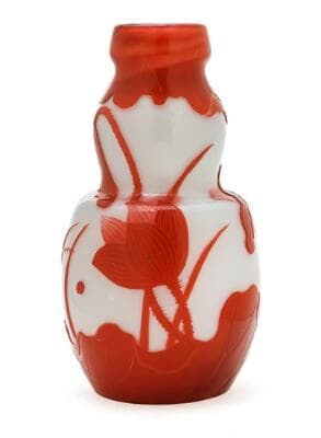 Emile Gallé: A fire polished pale blue glass vase overlaid with reddish-orange