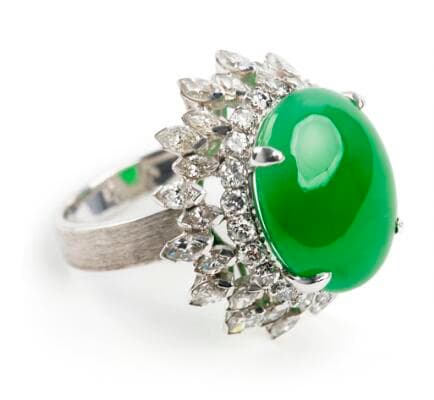 A 'Fei Cui' jade ring set with a jadeite jade encircled by numerous