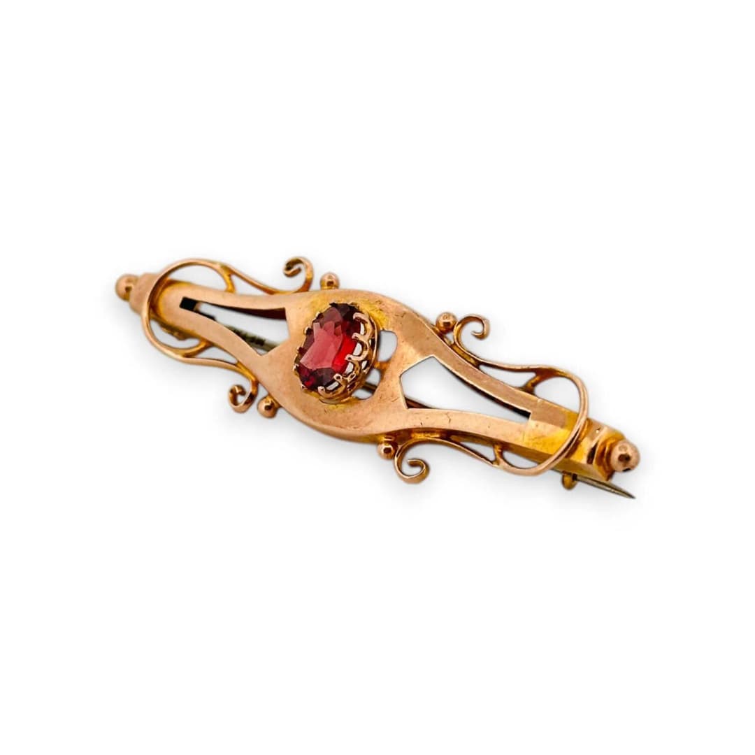 Spindle brooch in 9K (375) yellow gold, set with an oval fac - Lot 272