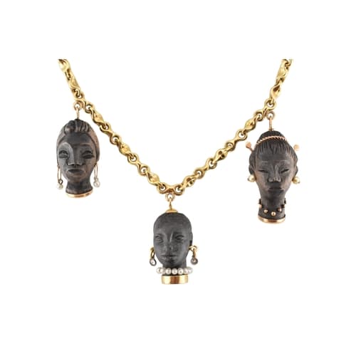 A blackamoor pendant 18ct gold necklace. The three Nubian fe...