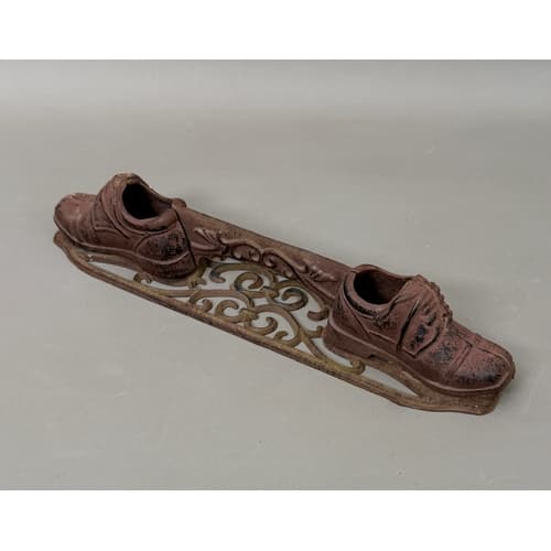 A Victorian style cast iron boot scraper - in the form of tw...