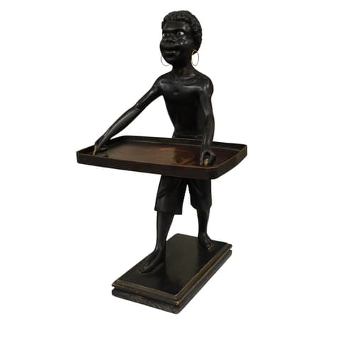 A blackamoor figure with glass eyes, holding a Japanese lacq...