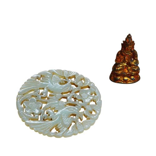 A Chinese jade disc, with pierced carved decoration5.5cm dia...